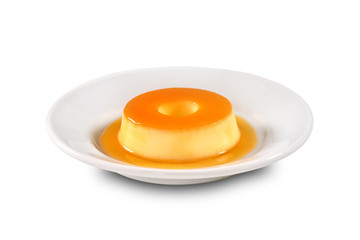 Vanilla pudim with caramel sauce on decorated scene
