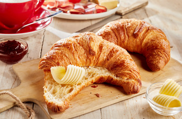Sliced croissant served with butter