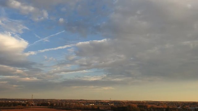 Time Lapse Clouds Over City With Cars And Traffic Blue Sky Silver Lining Jet Streams In Sky