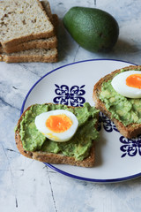 Toast with avocado and egg, bread slice with avocado and egg