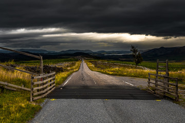 Narrow Road Through Rural Highland Landscape Near Loch Ness In Scotland