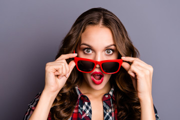 Naklejka premium Close up portrait of beautiful amazing wondered she her lady hands hold specs mouth opened in big shock red dark bright summer specs wearing casual checkered shirt isolated grey background