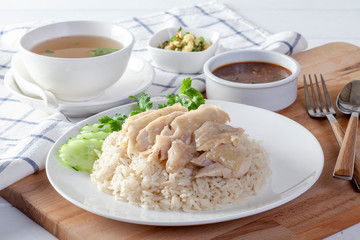 Hainanese chicken rice , Steamed chicken with rice, Khao Mun Kai on wood background