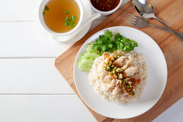 Hainanese chicken rice , Steamed chicken with rice, Khao Mun Kai on wood background
