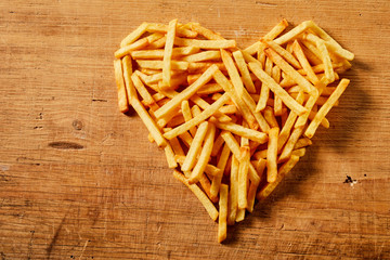 Close-up of heart shape made of tasty French fries