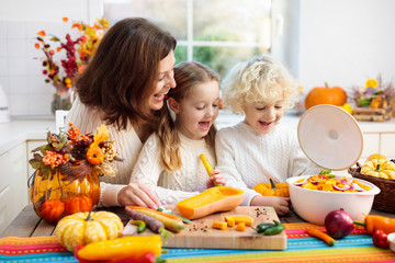 Family cooking pumpkin soup for Halloween lunch