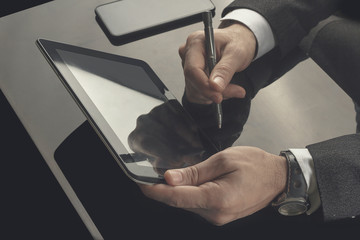 Businessman working in the office with communication equipments