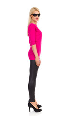 Fototapeta premium Serious Beautiful Blond Woman Is Standing. Side View.