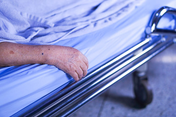 Asian senior or elderly old lady woman patient smile bright face with strong health while lying on bed in nursing hospital ward : healthy strong medical concept 