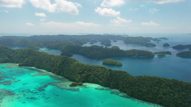 Aerial view of South Rock Islands (Chelbacheb), lush green islets around Mecherchar island, seascape with colorful coral reefs and tropical lagoons - landscape panorama of Micronesia from above, Palau