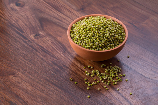 Fresh Green Tender Sorghum in a Earthen Bowl on Wooden Background