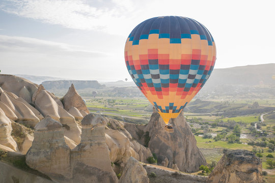 colourful hot air balloon floating over the valley in Turkey, Cappadocia 