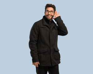 young man doing listening gesture