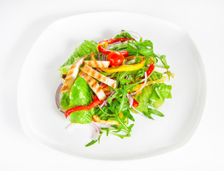 Delicious salad with meat, tomatoes and greenery on white