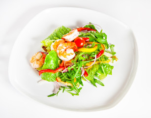 Delicious salad with shrimp, tomatoes and greenery on white