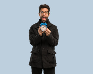 young man holding an clock