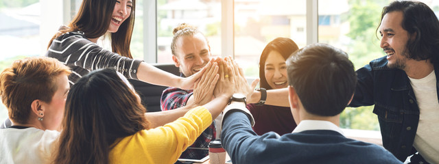 Gesture hand high five of Group employee laughing together with achivement mission at millenial company. Casual business with startup friends teamwork community celebration, win and conquest concept
