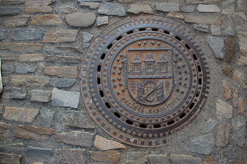 sewer hatch, old iron sewer hatch, stones