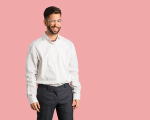 Fototapeta premium Young handsome business man winking, funny, friendly and carefree gesture