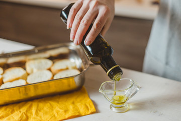 Closeup of hands pouring virgin olive or sunflower oil
