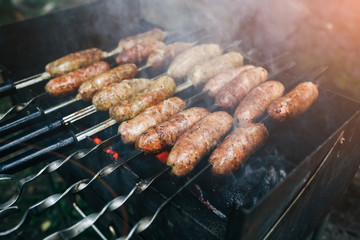 Homemade grilled sausages outdoors. Tasty food for barbecue party.