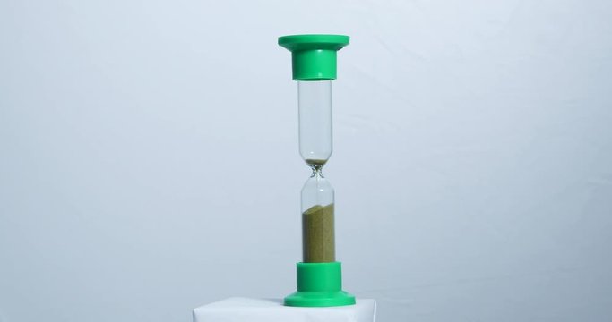 Sand falls quickly through an hourglass.