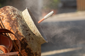 Construction site work with concrete mixer and wheelbarrows