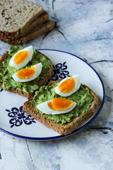 Toast with avocado and egg, bread slice with avocado and egg