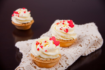 Delicious cupcakes for Valentine Day on black background