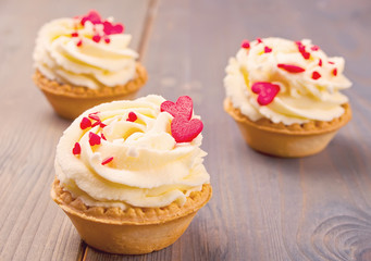 Delicious cupcakes for Valentine Day on wooden background