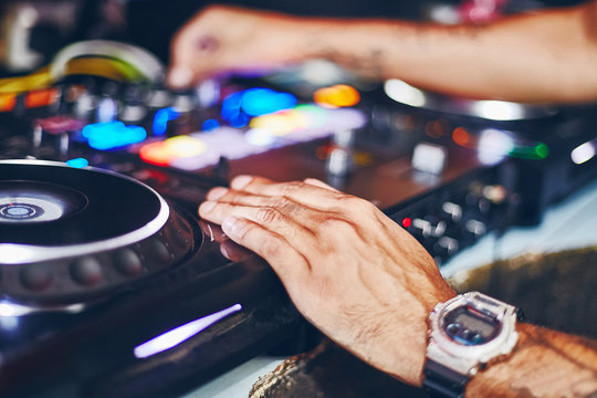 DJ playing box with mixing music on turntables and vinyl records