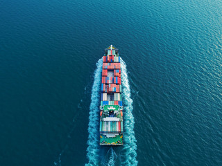 Aerial view container ship full speed for logistics shipping, import export or transportation concept background.