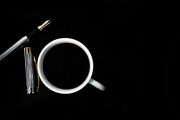 A cup of black coffee with men's cufflinks and a fountain pen. Concept fashion business style. 