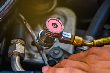 Mechanic check car air conditioner system in garage