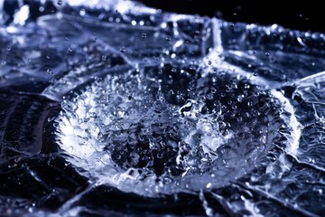 Water drops splashing on acoustic membrane. A lot of drops in air. High frequency of sound waves....