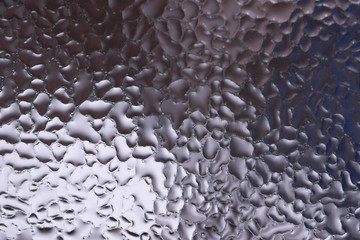 Water drops on glass window close up with blurred background. Drops in macro. Condensate on window...