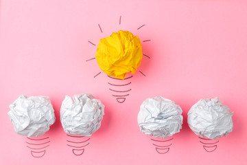 Concept creative idea. concept of creative idea. Crumpled paper balls and painted light bulb on bright background. metaphor, inspiration.