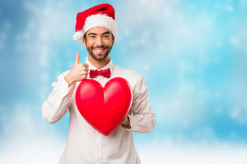 Young man wearing a santa claus hat on Christmas day