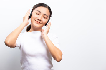 Woman in headphones listening to music isolated over white background