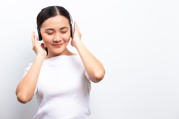 Woman in headphones listening to music isolated over white background