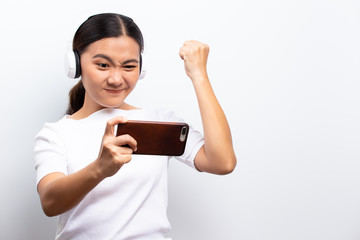 Fototapeta premium Happy woman playing to the game from smartphone