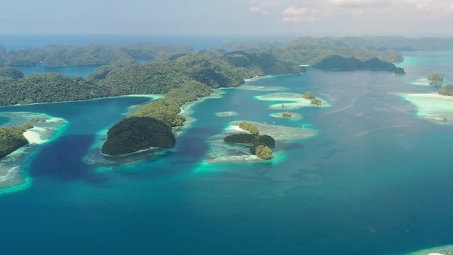 Aerial view of South Rock Islands (Chelbacheb), lush green islets around Mecherchar island, seascape with colorful coral reefs and tropical lagoons - landscape panorama of Micronesia from above, Palau