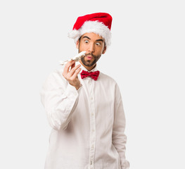 Young man wearing a santa claus hat on Christmas day