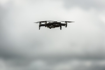 Fototapeta na wymiar Drone quadcopter UAV with digital camera flying in the sky.