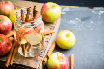Apple and cinnamon detox drink in jar. Selective focus.