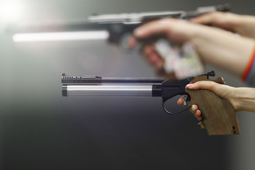 The girl's hand which shoots from professional pneumatic gun