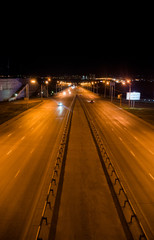 Fototapeta na wymiar Cars drive at night on the motorway.