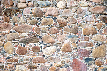 Full frame texture background of a rubble stone wall construction