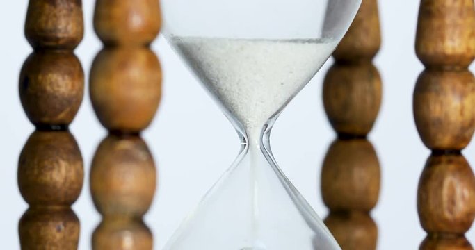 Sand falls quickly through an hourglass.