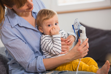 mother inhaling her son with nebuliser